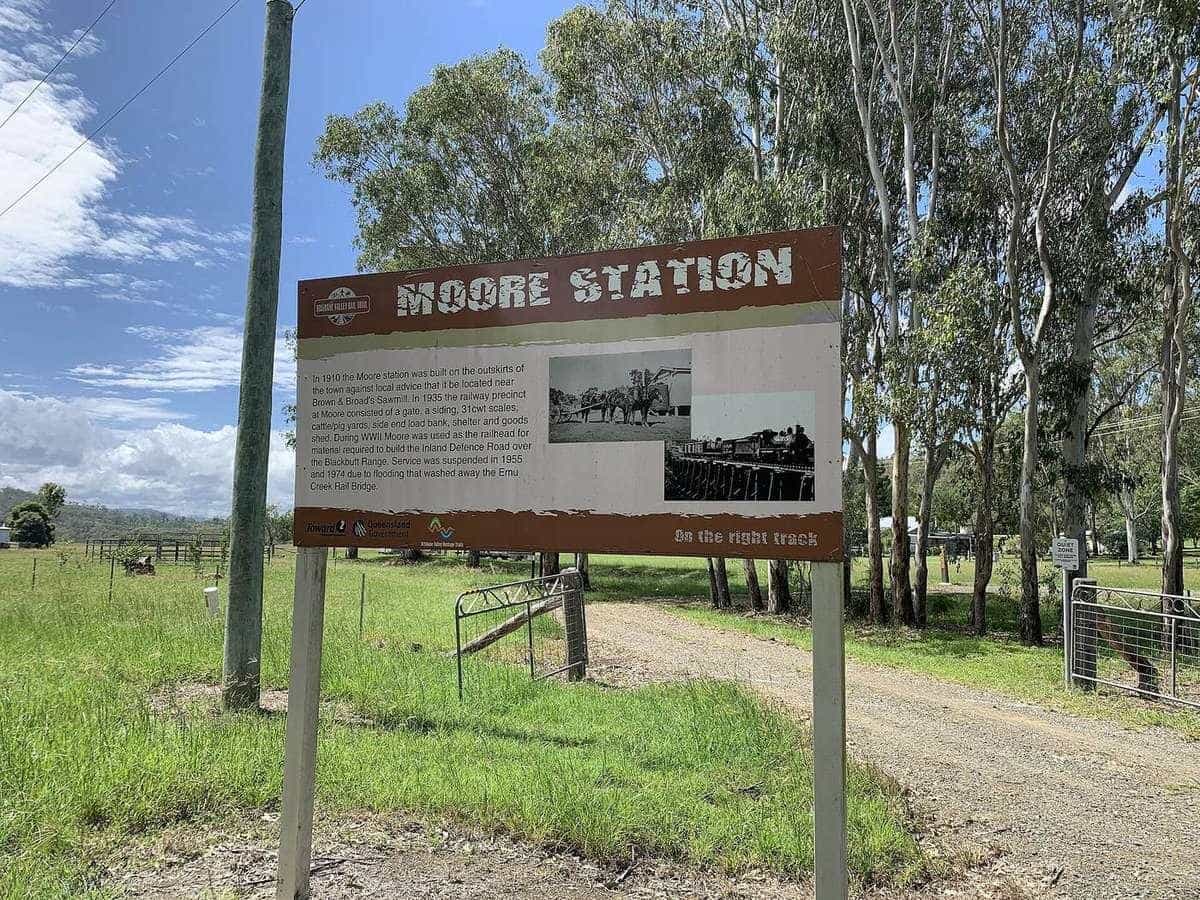 Brisbane Valley Rail Trail signage at the former Moore railway station, with the trail stretching into the distance