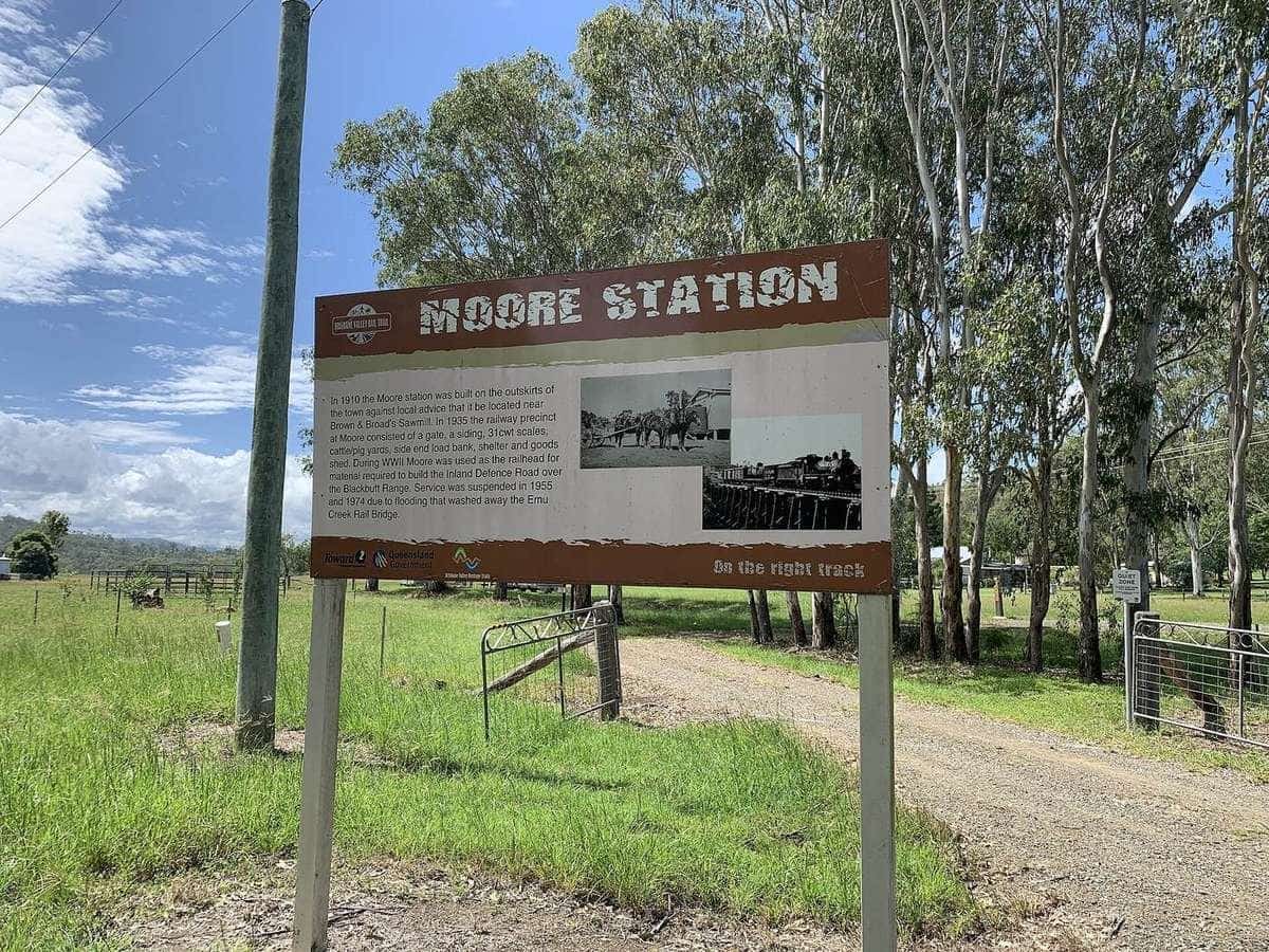 Brisbane Valley Rail Trail signage at the former Moore railway station, with the trail stretching into the distance
